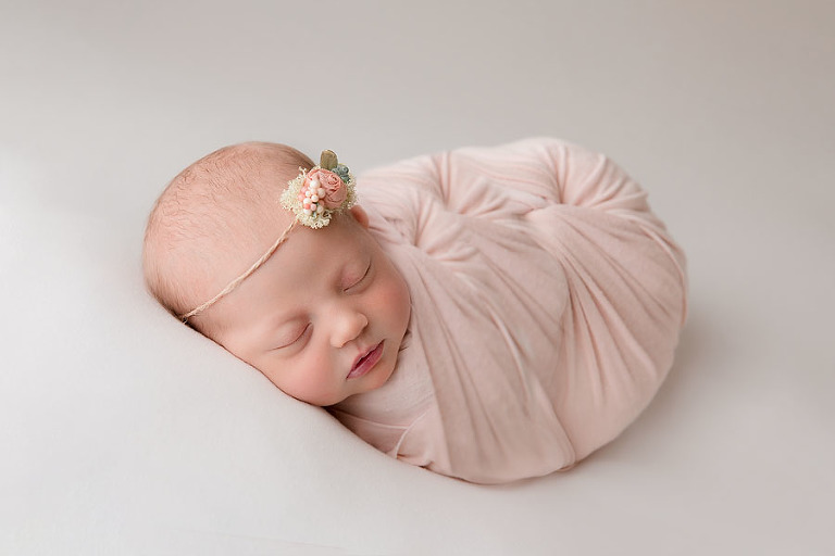 newborn baby wrapped in pink