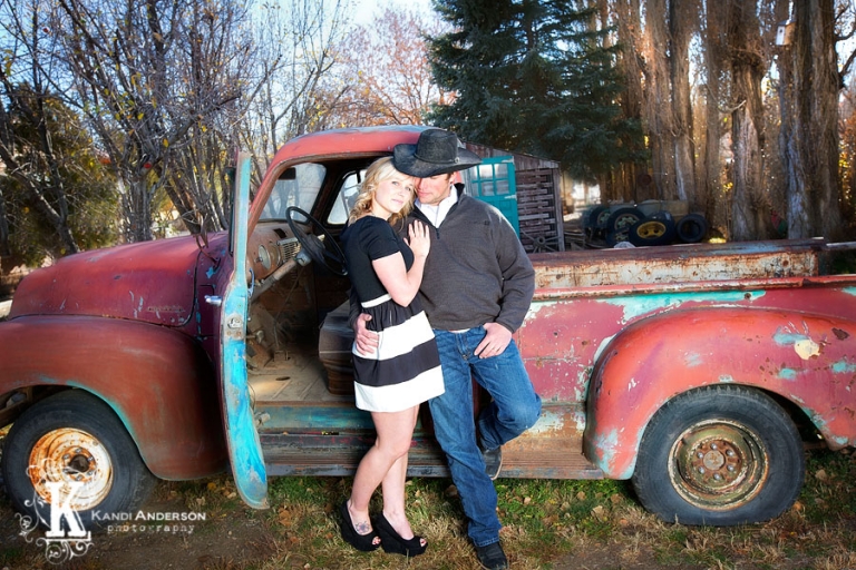 young couple photgraphed next to old truck