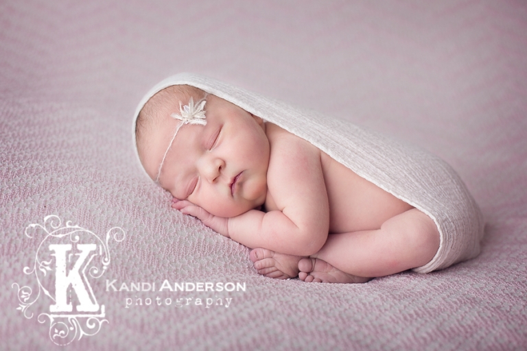 newborn baby with cute wrap and dainty headband