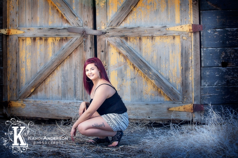 Carlin High School Senior in front of old yellow barn