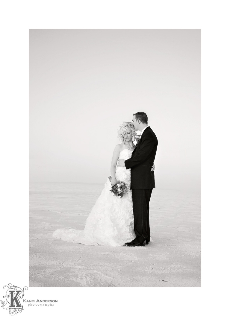 black and white image with young couple on Bonnieville Salt flats in West Wendover Utah