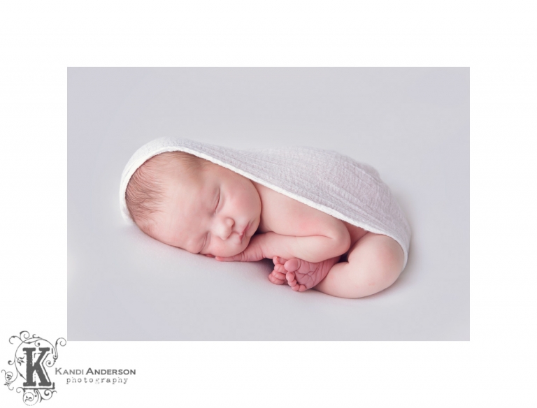 womb pose with newborn baby boy