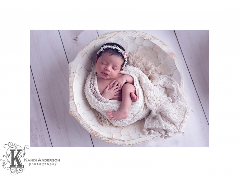 baby girl in neutral wrap and white bucket