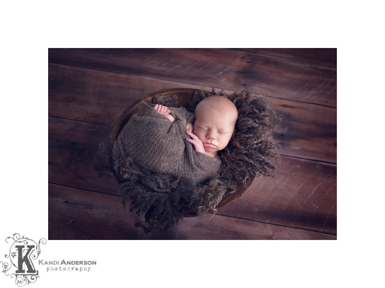 newborn in brown bowl of wool